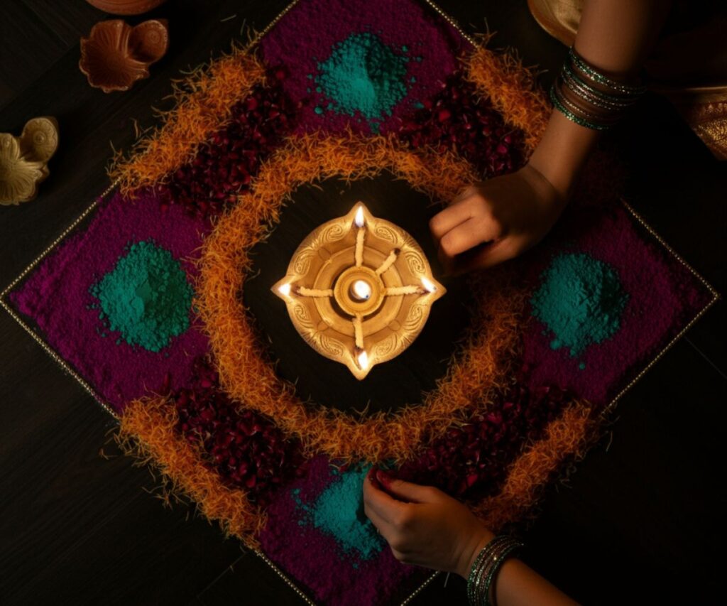 Hands carefully crafting a colorful rangoli design on the floor as a welcoming gesture for the festival.